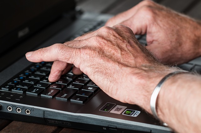 Older hands on keyboard