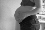 Pregnant woman torso, side view